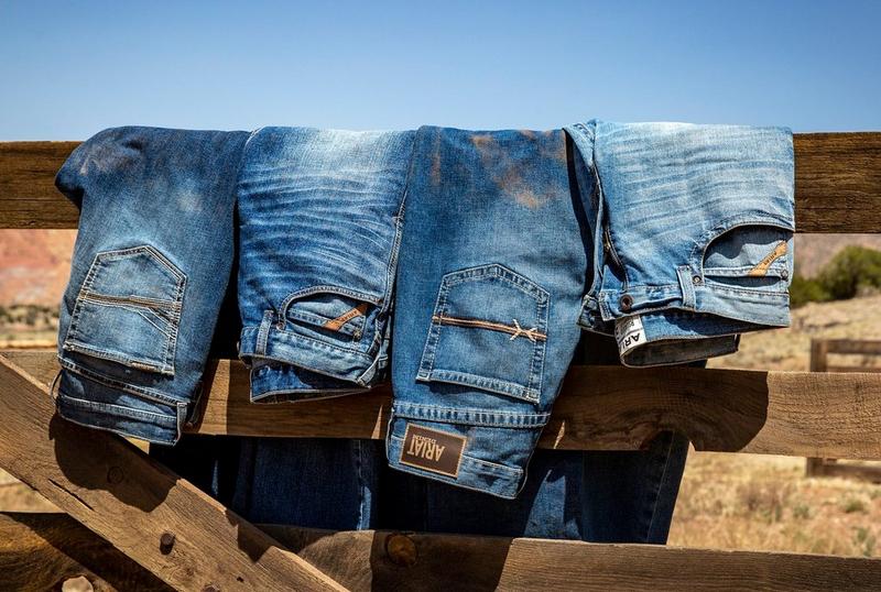 Ariat Denim Jeans folded on Fence
